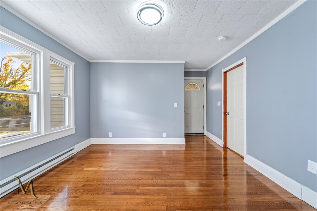 19-21 Daniel Street, Unit 19 Springfield, MA 01151 - Photo 11 of 26 an empty room with wooden floor and windows
