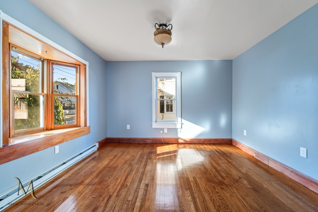 19-21 Daniel Street, Unit 19 Springfield, MA 01151 - Photo 12 of 26 a view of an empty room with wooden floor and a window
