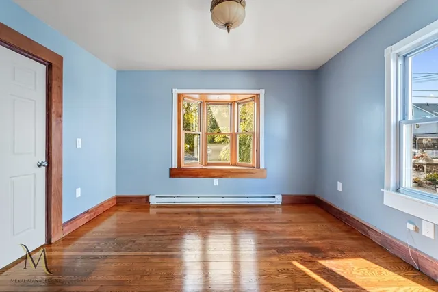 wooden floor in an empty room with a window