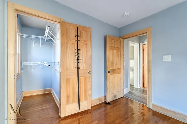 a view of a bathroom with wooden floor and a small space
