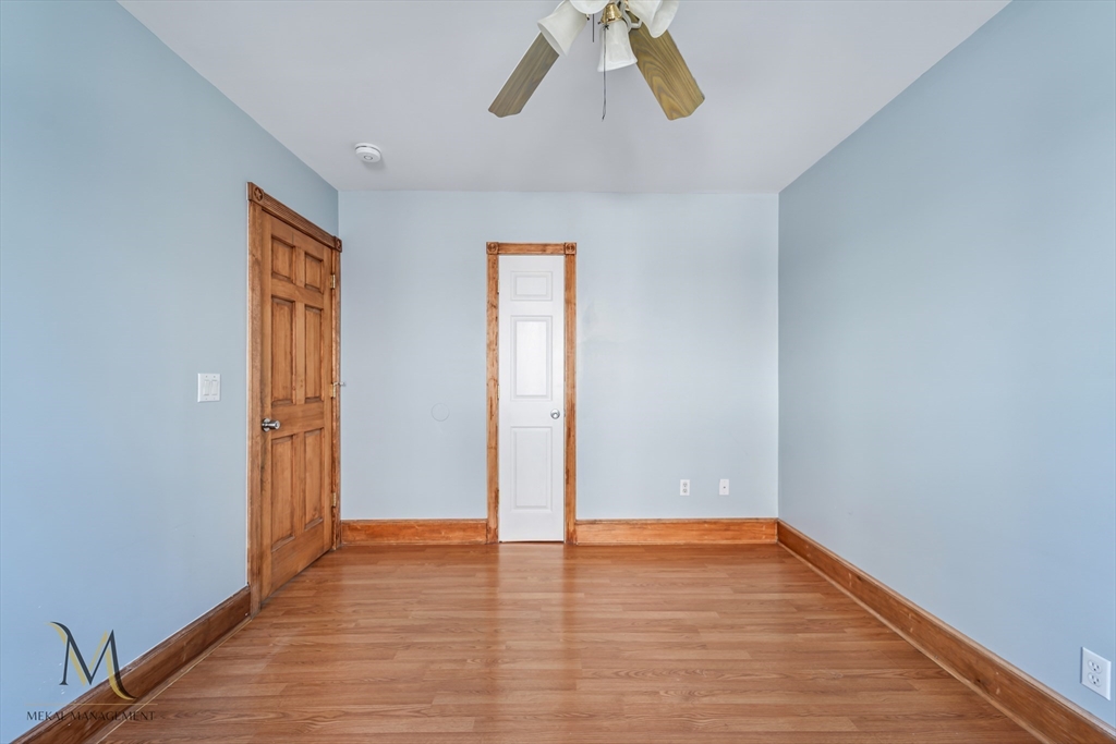19-21 Daniel Street, Unit 19 Springfield, MA 01151 - Photo 21 of 26 a view of an empty room with wooden floor and a window