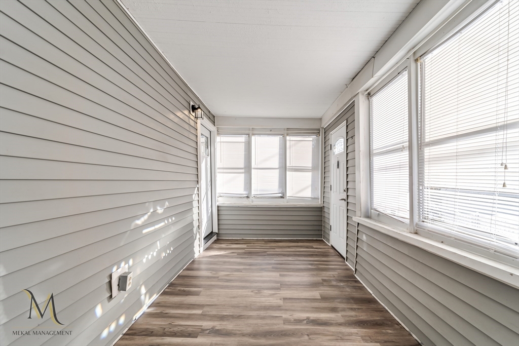 19-21 Daniel Street, Unit 19 Springfield, MA 01151 - Photo 23 of 26 a view of a porch with wooden floor and windows