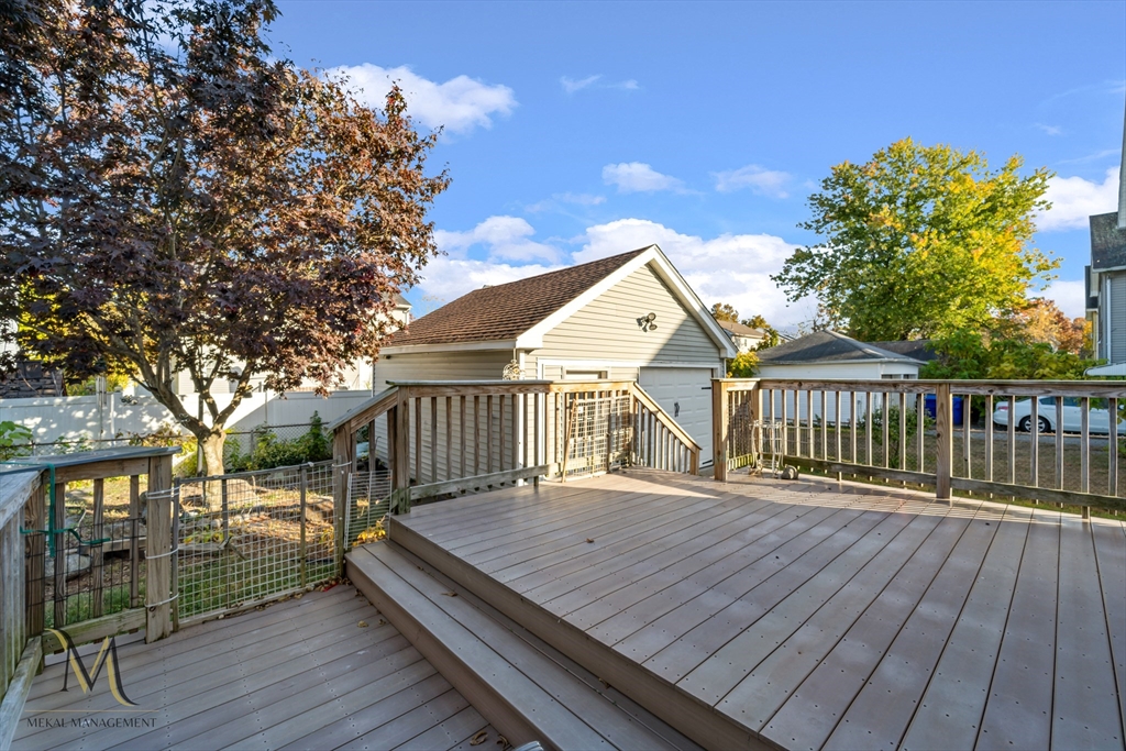 19-21 Daniel Street, Unit 19 Springfield, MA 01151 - Photo 24 of 26 a view of a wooden deck with a yard