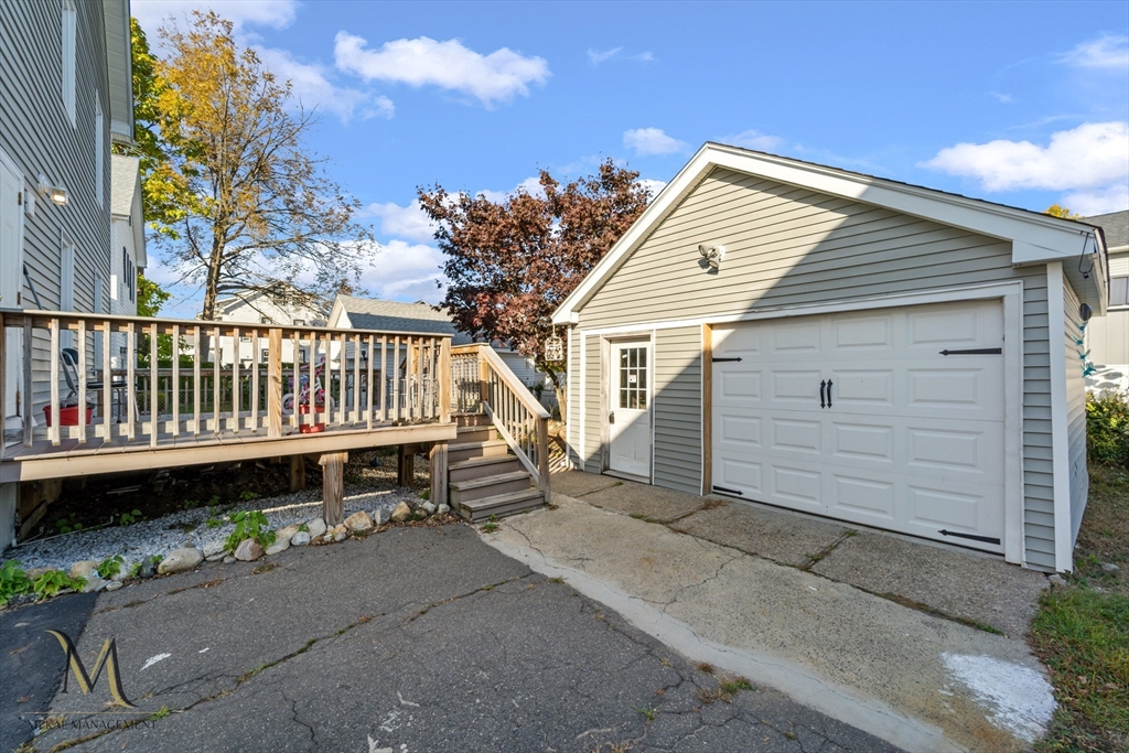 19-21 Daniel Street, Unit 19 Springfield, MA 01151 - Photo 26 of 26 a view of a chair and table in the back yard of the house
