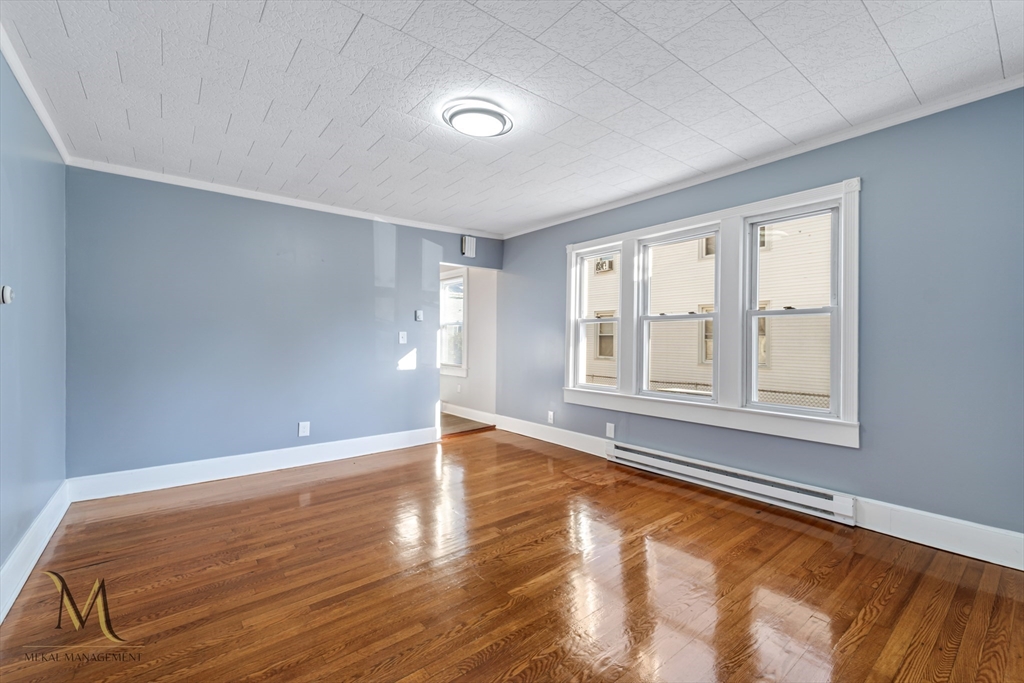 19-21 Daniel Street, Unit 19 Springfield, MA 01151 - Photo 8 of 26 a view of an empty room with wooden floor and a window