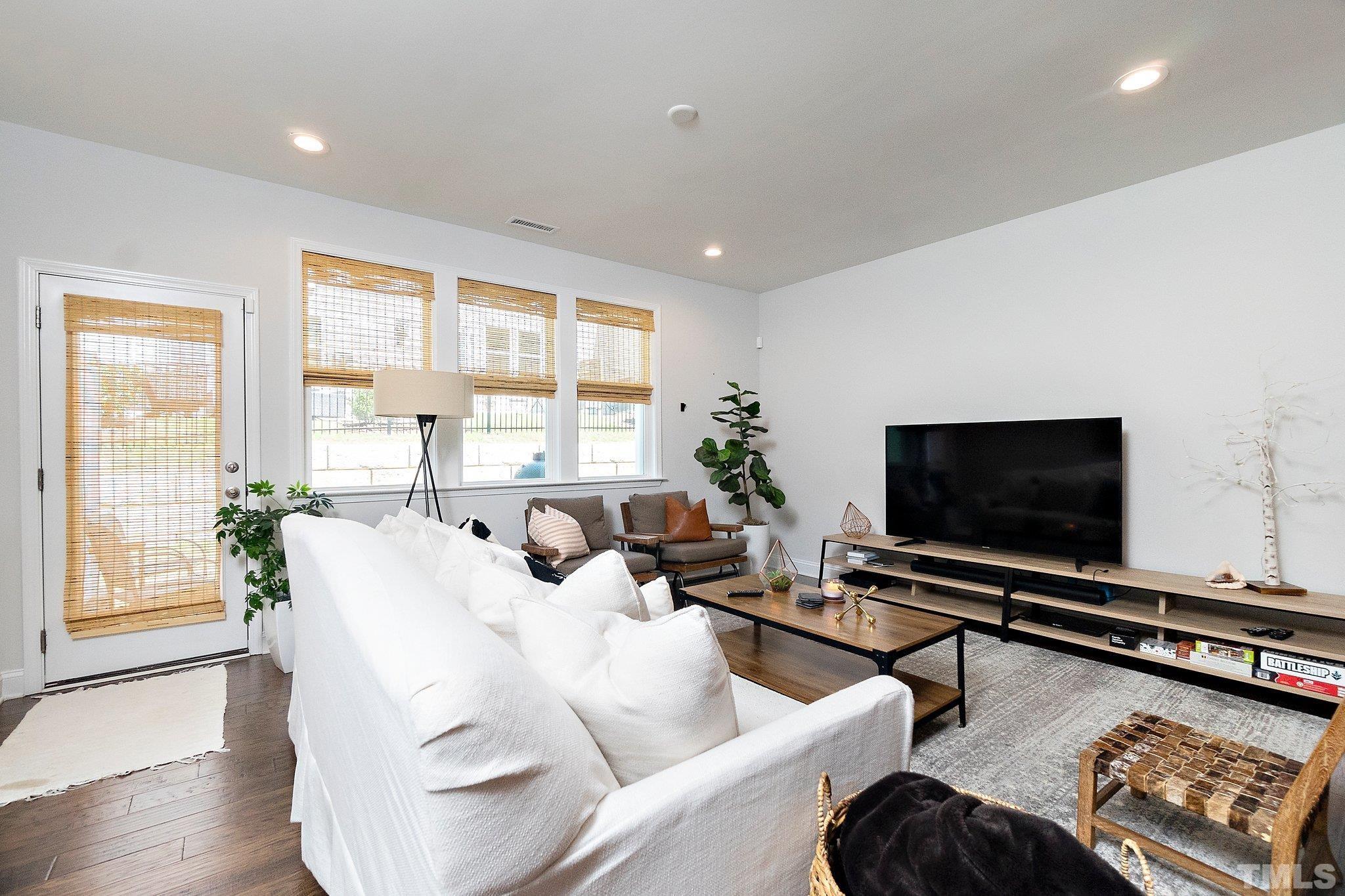 821 Malta Way Durham, NC 27703 - Photo 12 of 30 a living room with furniture and a flat screen tv