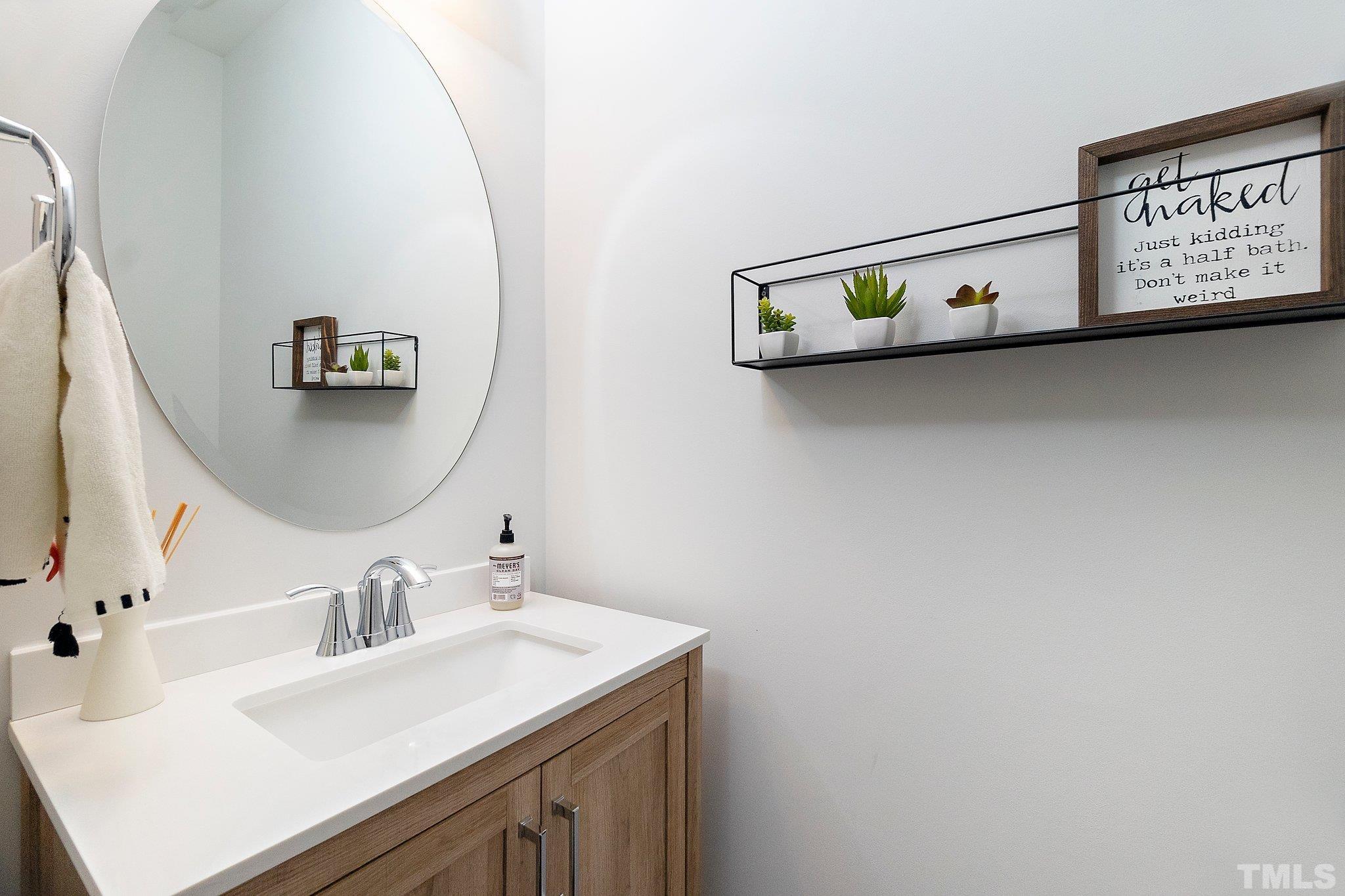 821 Malta Way Durham, NC 27703 - Photo 18 of 30 a bathroom with a sink and a mirror