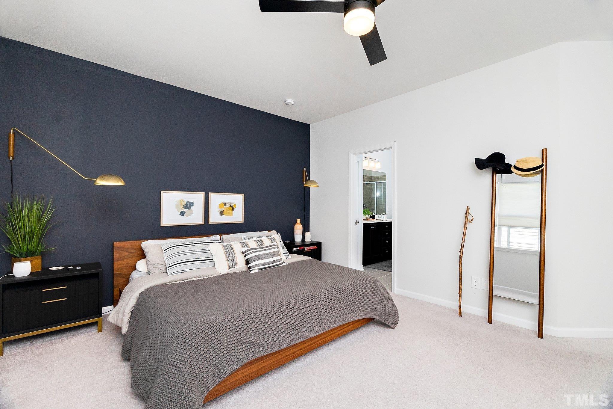 821 Malta Way Durham, NC 27703 - Photo 19 of 30 a bedroom with a bed and ceiling fan