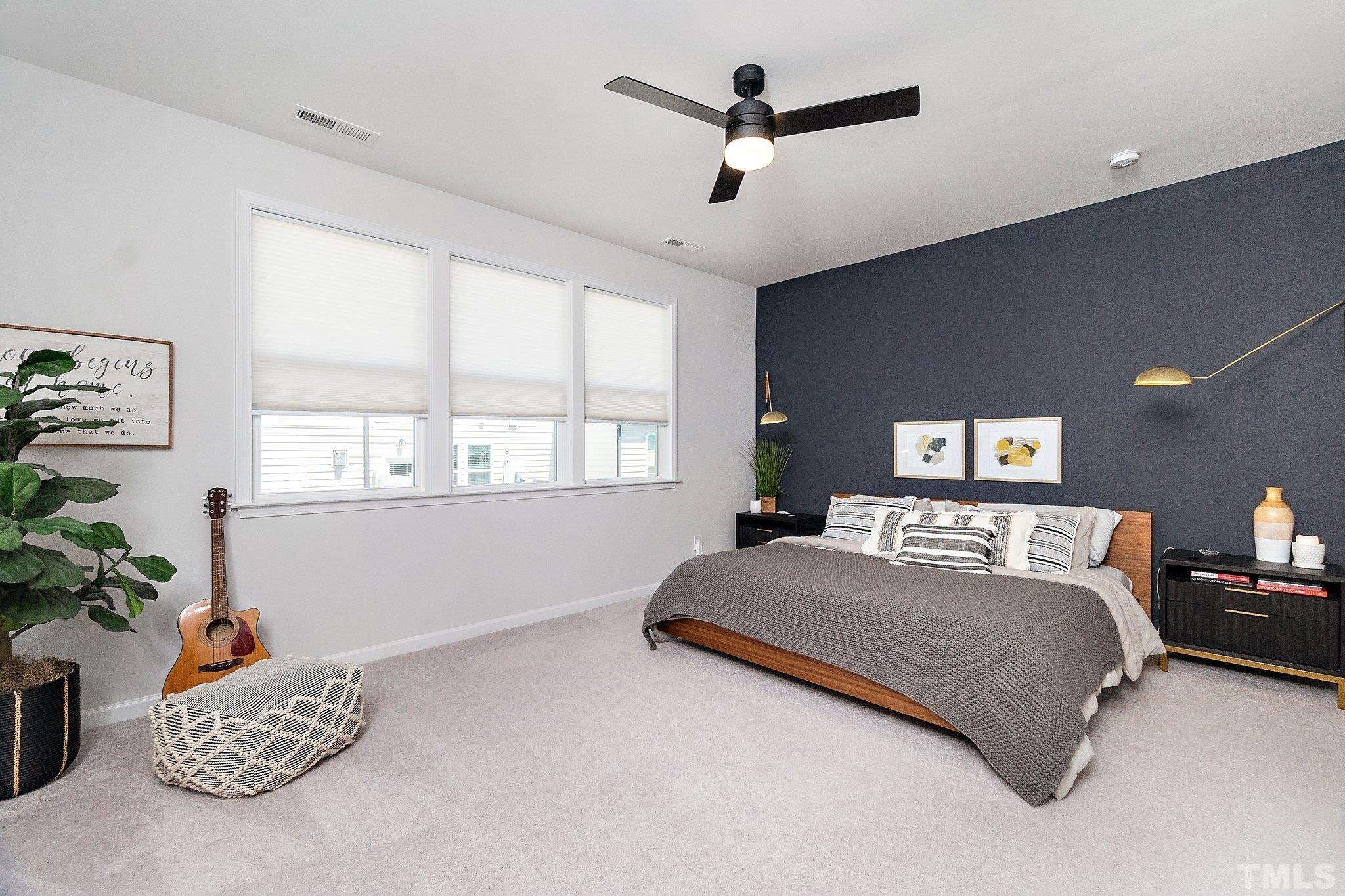 821 Malta Way Durham, NC 27703 - Photo 20 of 30 a bedroom with a bed chandelier potted plant on dresser and a window