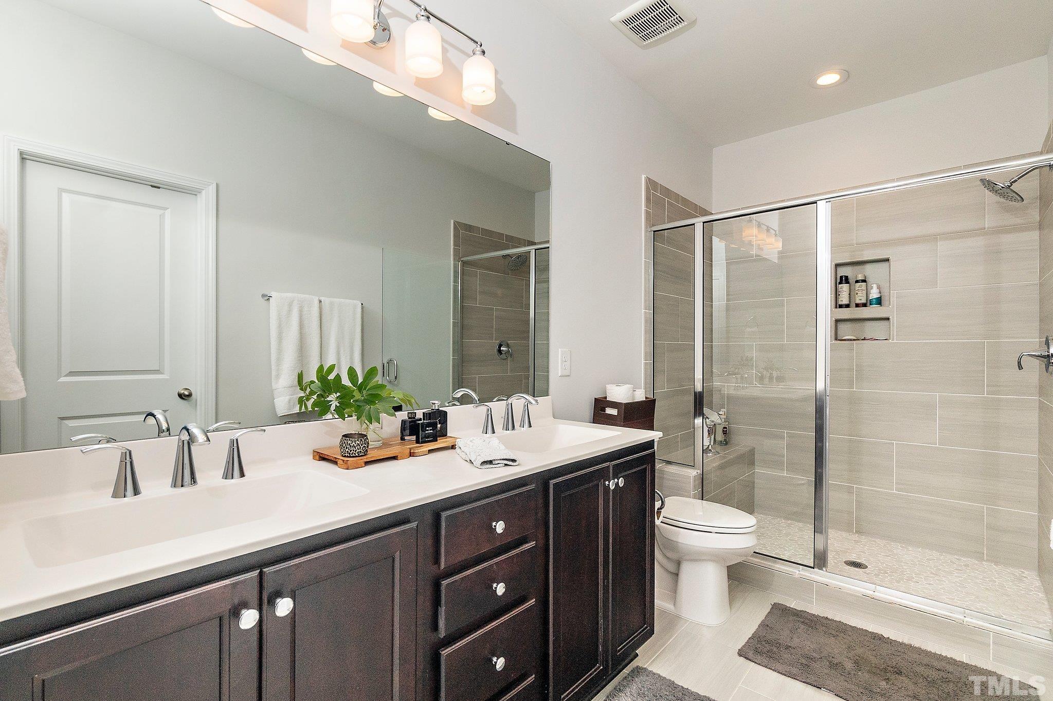 821 Malta Way Durham, NC 27703 - Photo 21 of 30 a spacious bathroom with a sink shower and a mirror