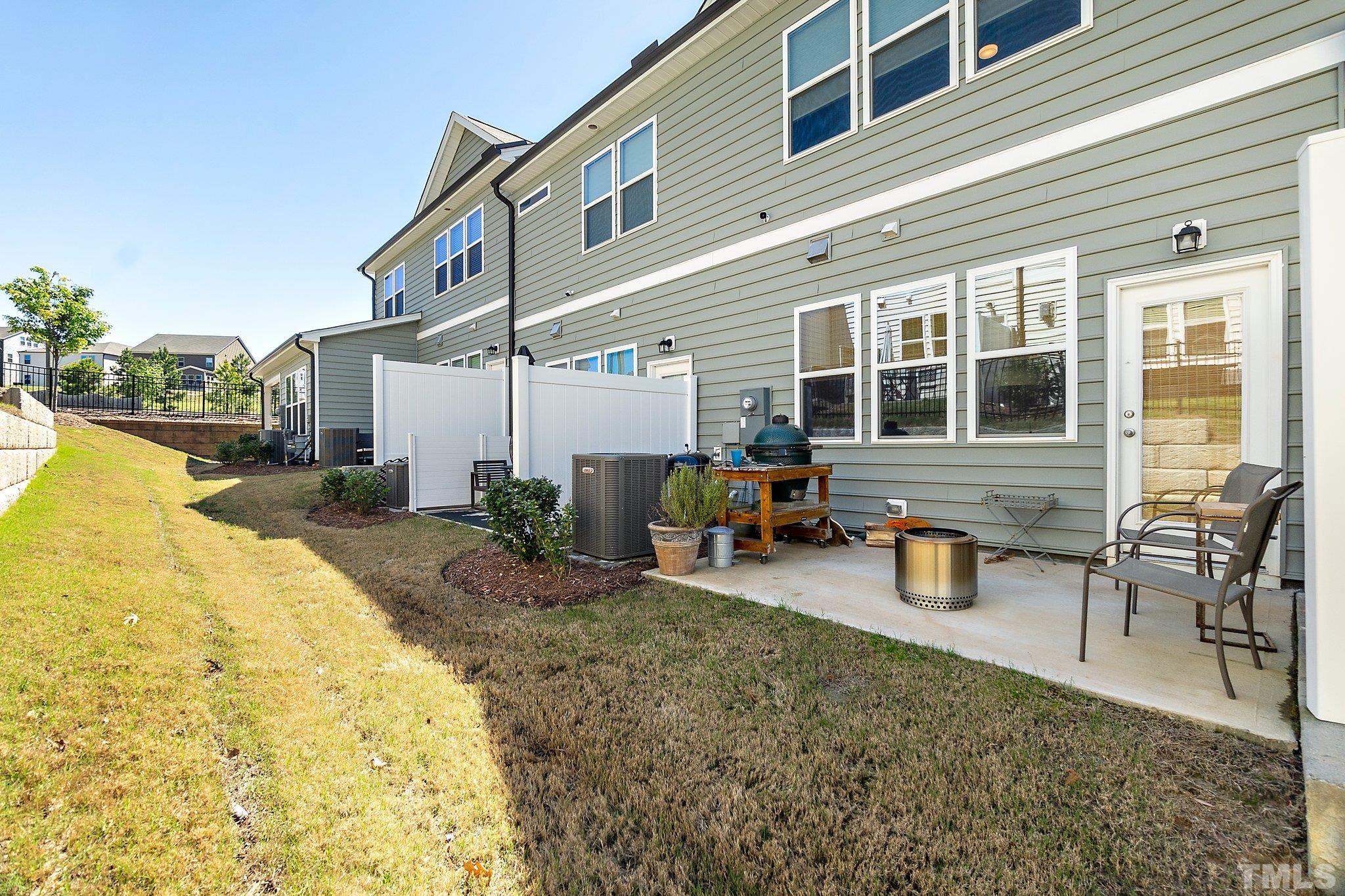 821 Malta Way Durham, NC 27703 - Photo 27 of 30 a view of a house with backyard and sitting area