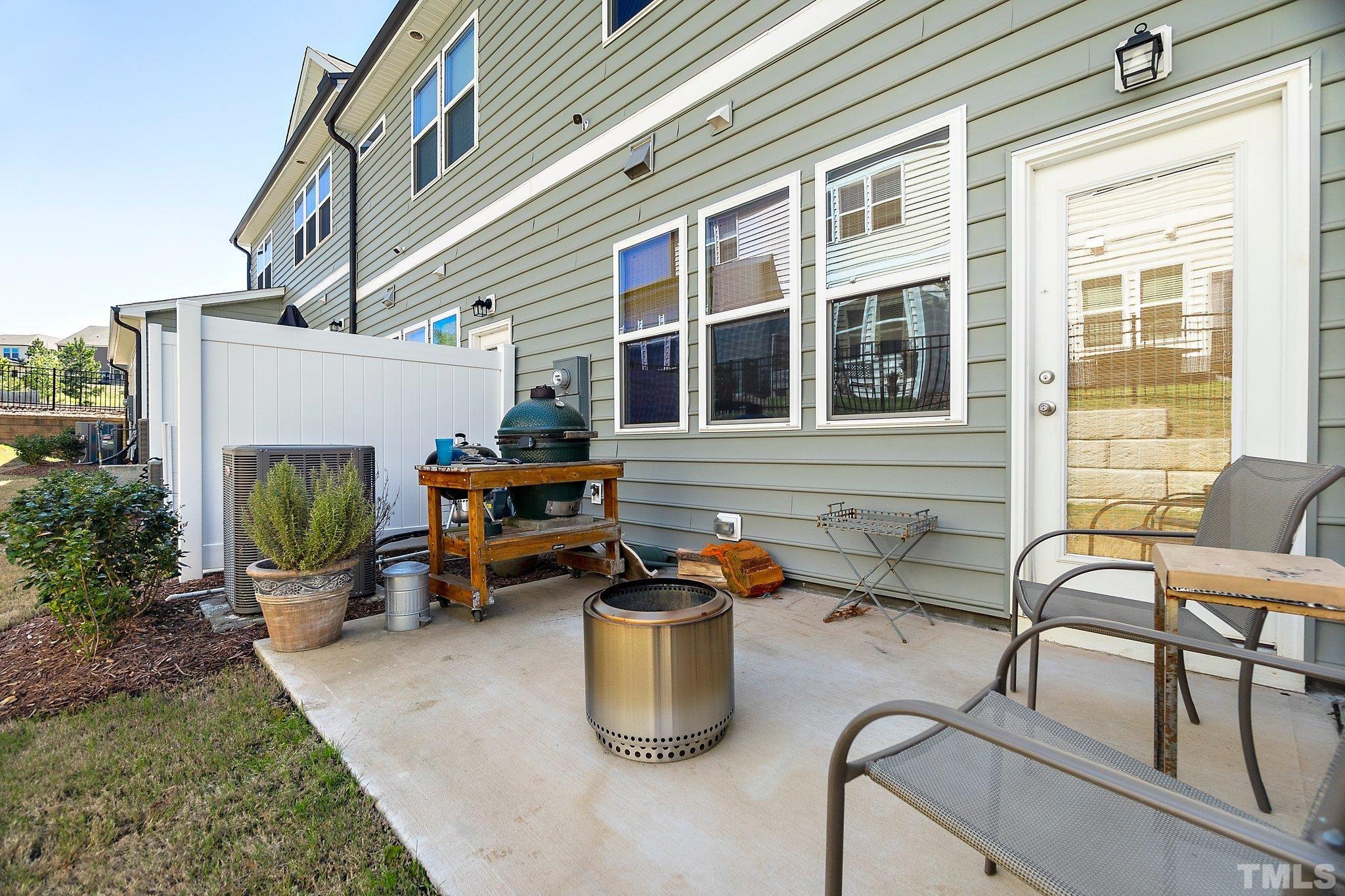 821 Malta Way Durham, NC 27703 - Photo 29 of 30 a view of a patio with table and chairs and potted plants