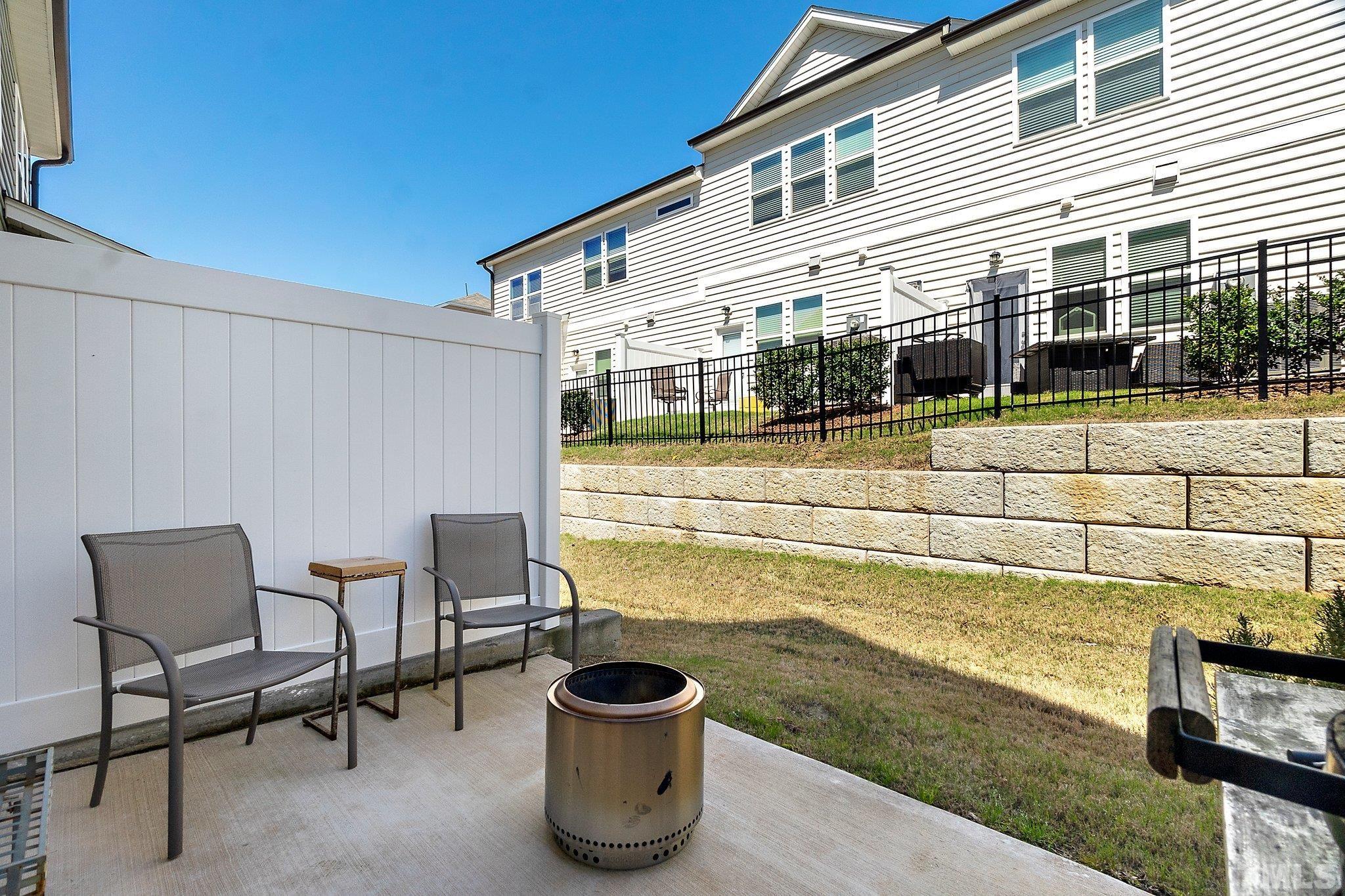 821 Malta Way Durham, NC 27703 - Photo 30 of 30 a view of a patio with table and chairs and wooden fence