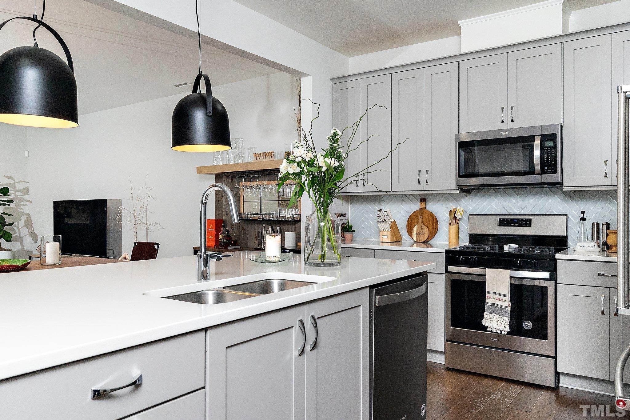 821 Malta Way Durham, NC 27703 - Photo 8 of 30 a kitchen with stainless steel appliances a sink a stove and microwave
