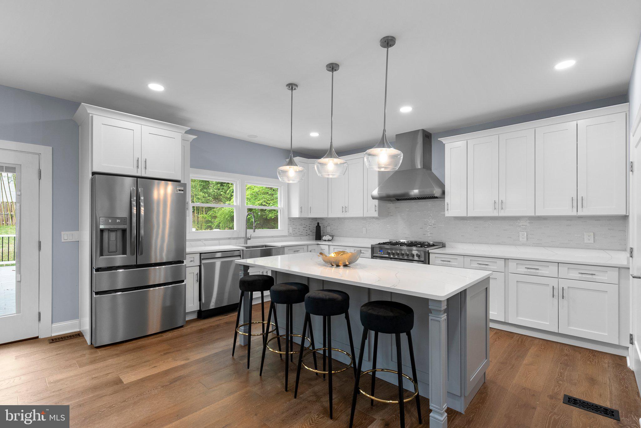 2924 Hunter Road Fairfax, VA 22031 - Photo 14 of 79 a kitchen with stainless steel appliances granite countertop a sink a stove a refrigerator and island with wooden floor