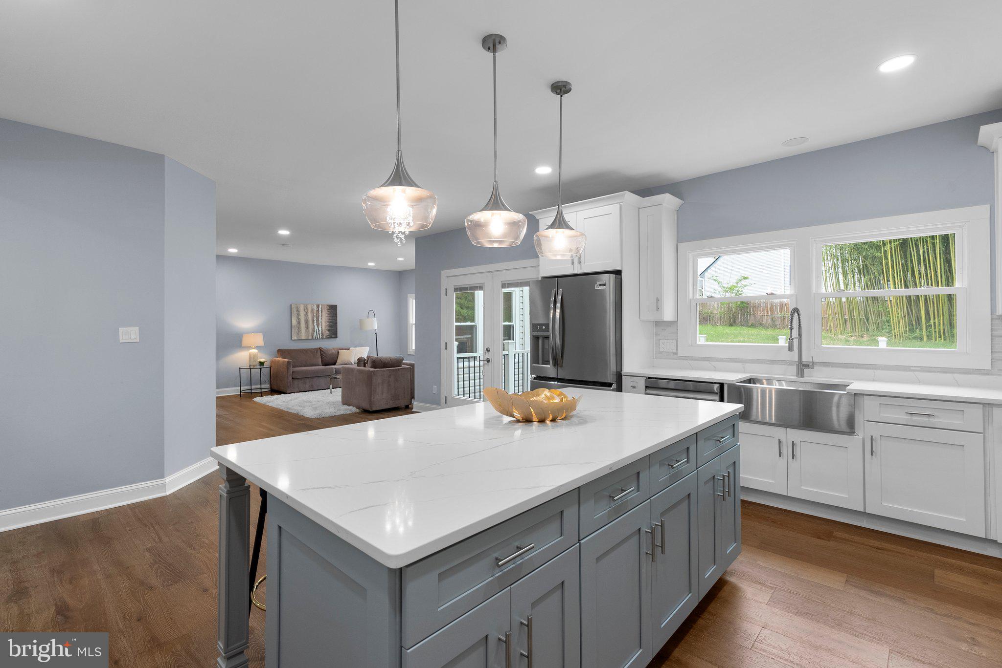2924 Hunter Road Fairfax, VA 22031 - Photo 15 of 79 a kitchen with a stove a kitchen island a sink and a living room view