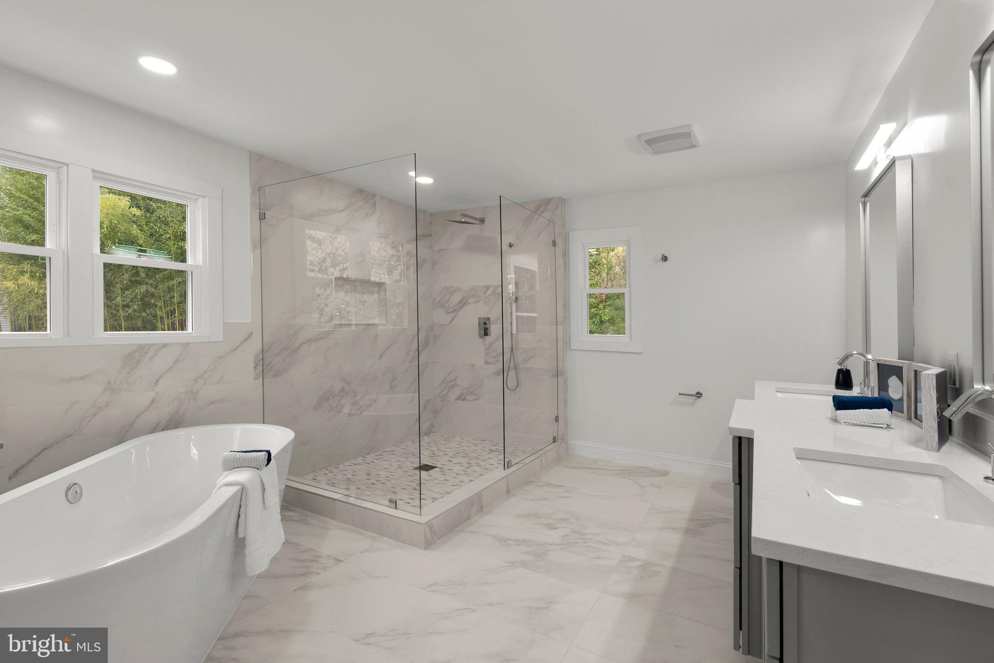 2924 Hunter Road Fairfax, VA 22031 - Photo 30 of 79 a bathroom with a tub sink toilet a mirror and a tub