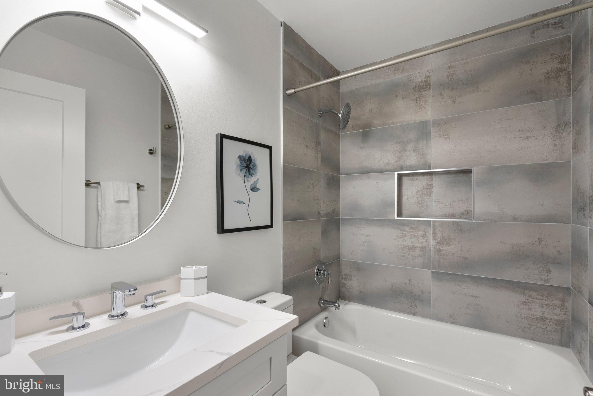 2924 Hunter Road Fairfax, VA 22031 - Photo 33 of 79 a bathroom with a bathtub shower sink and mirror