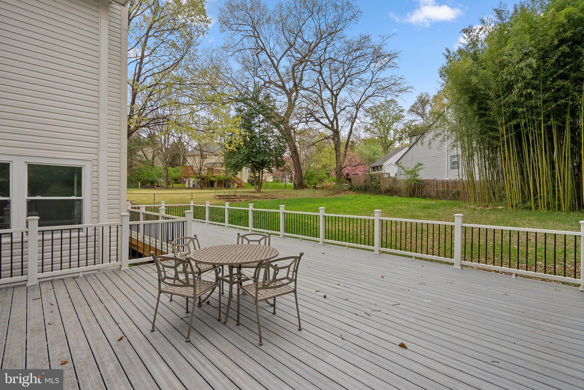 2924 Hunter Road Fairfax, VA 22031 - Photo 52 of 79 a view of a roof deck with table and chairs and wooden floor
