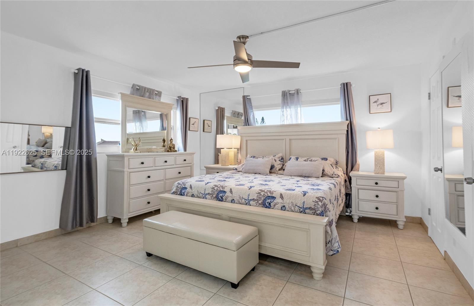 400 North Surf Road, Unit 506 Hollywood, FL 33019 - Photo 16 of 37 a bedroom with a bed and ceiling fan