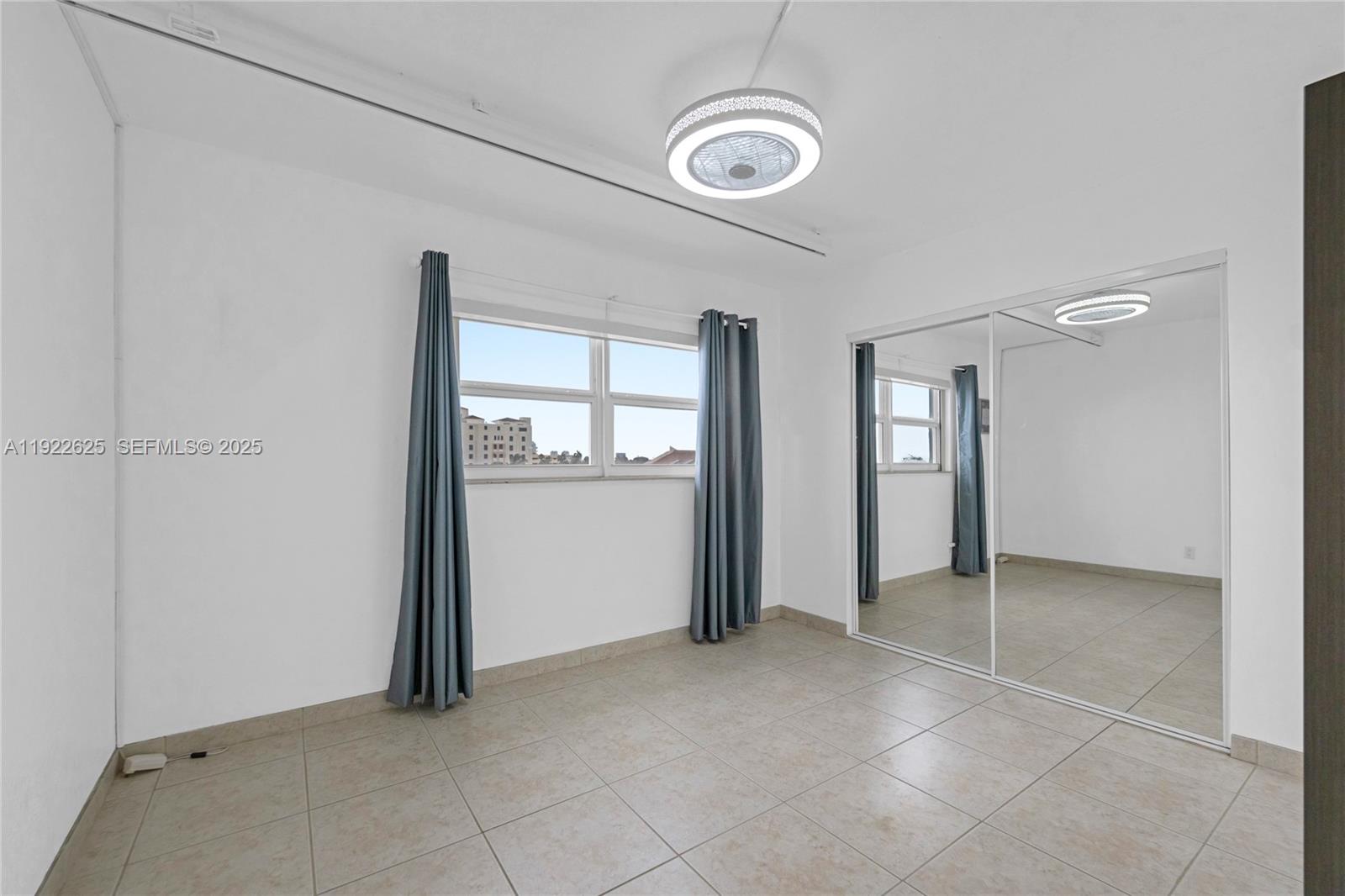 400 North Surf Road, Unit 506 Hollywood, FL 33019 - Photo 23 of 37 an empty room with windows and closet