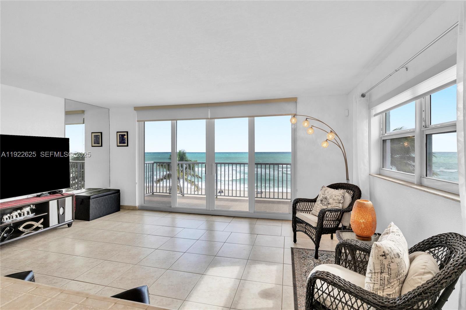 400 North Surf Road, Unit 506 Hollywood, FL 33019 - Photo 6 of 37 a living room with furniture and a flat screen tv
