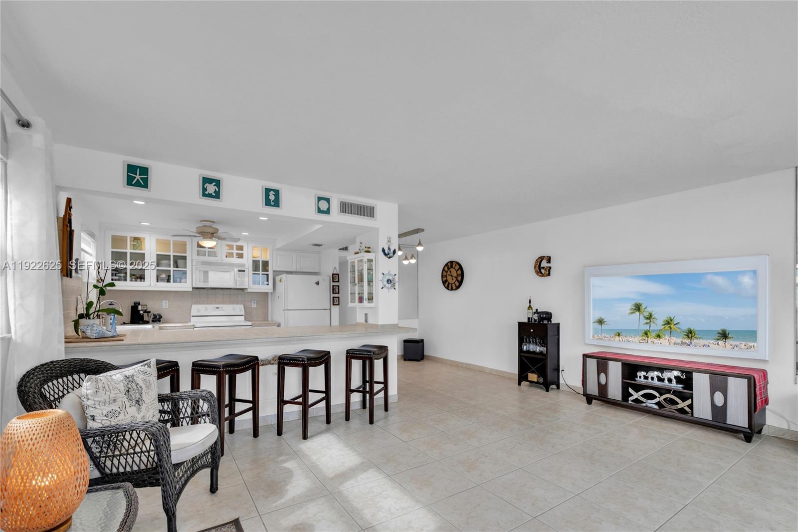 400 North Surf Road, Unit 506 Hollywood, FL 33019 - Photo 10 of 37 a living room with furniture and painting on the wall