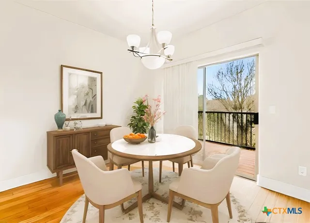 a dining room with furniture and window