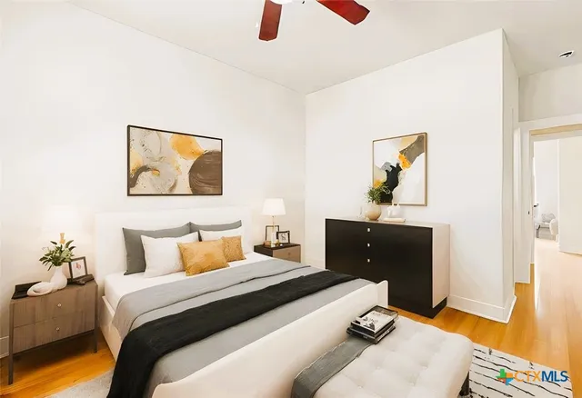 a bedroom with a bed and a chandelier