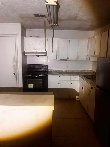 a kitchen with a sink stainless steel appliances and cabinets