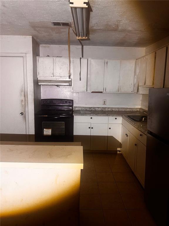 a kitchen with a sink stainless steel appliances and cabinets
