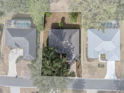 an aerial view of multiple houses with yard