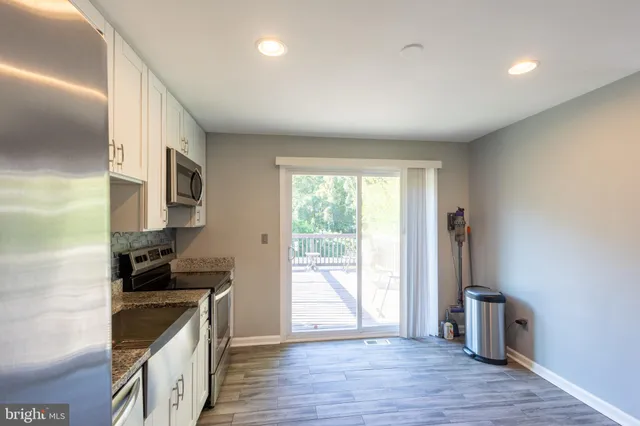 a kitchen with stainless steel appliances granite countertop a stove and a refrigerator