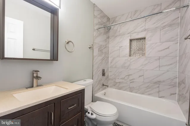 a bathroom with a sink a toilet and bathtub
