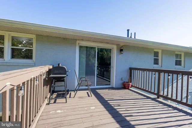 a view of a deck with wooden floor and seating space