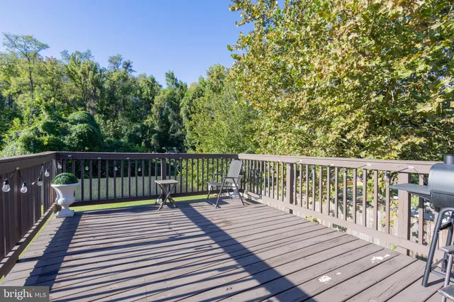 a view of balcony with wooden floor and fence