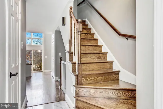 a view of entryway and hall with wooden floor