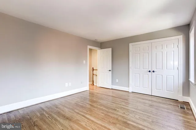 a view of an empty room and wooden floor