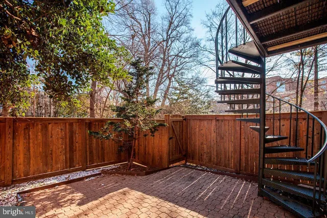 a view of a backyard with wooden fence