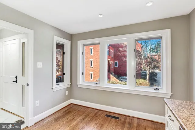 a view of a livingroom with wooden floor and a window
