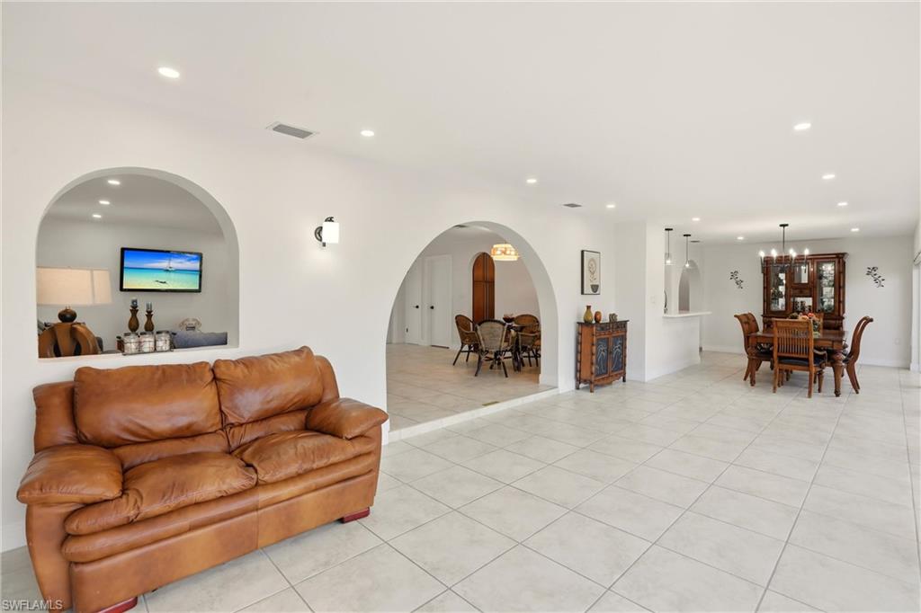 339 Landmark Street Marco Island, FL 34145 - Photo 26 of 50 Living room featuring recessed lighting, light tile patterned flooring, and arched walkways