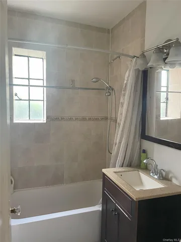 a bathroom with a sink mirror toilet and bathtub
