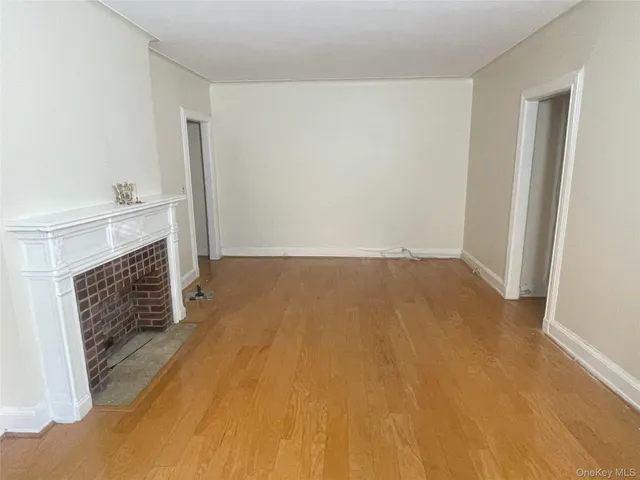 a view of empty room with a fireplace
