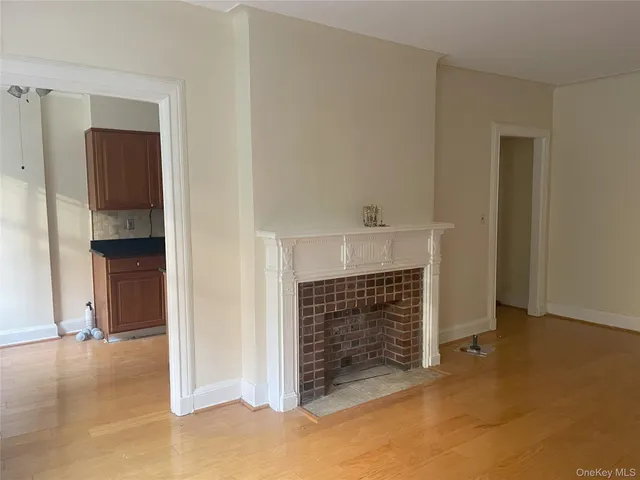 a view of an empty room with a fireplace