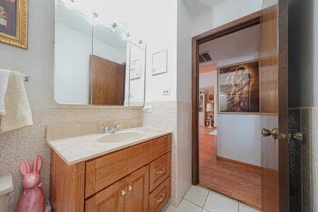 a bathroom with a sink vanity and a mirror