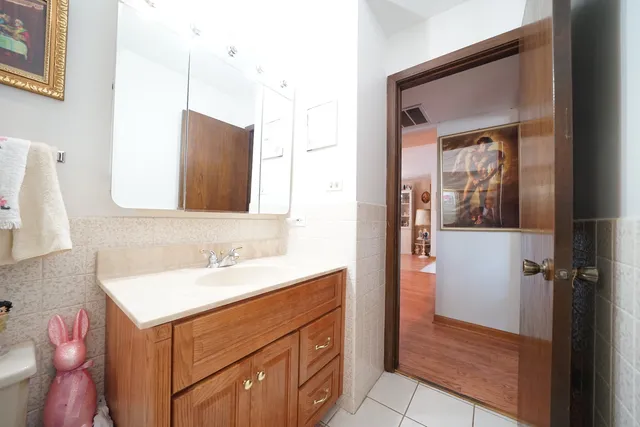 a bathroom with a sink vanity and a mirror