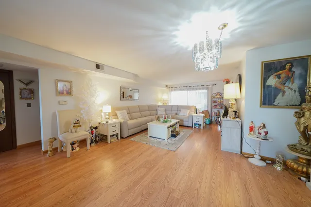 a living room with furniture and a chandelier
