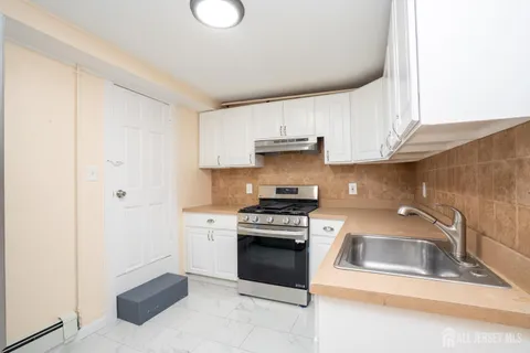 a kitchen with a sink cabinets and stainless steel appliances