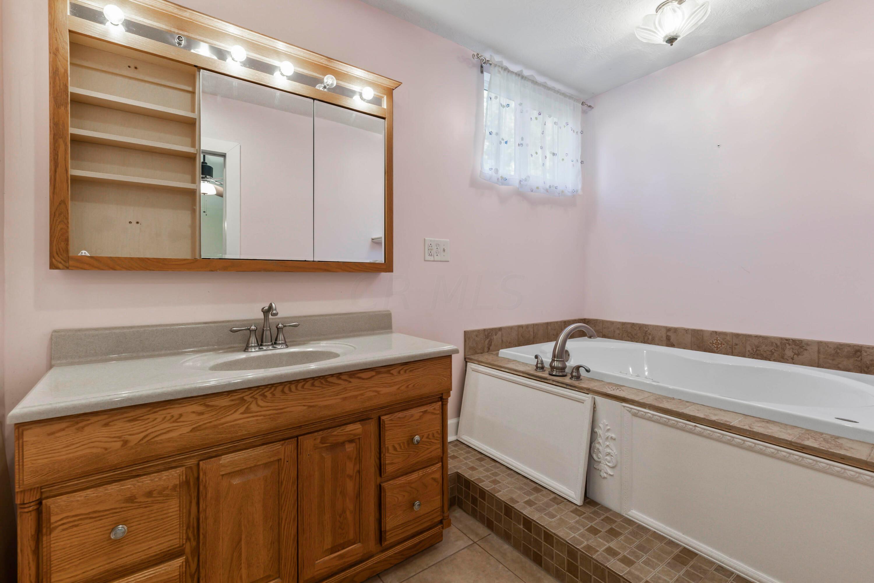 9495 Kilbourne Road Sunbury, OH 43074 - Photo 60 of 84 • Ceramic tile flooring
• Rose painted walls
• Shower stall with glass doors
• Lighted ceiling exhaust
• Jacuzzi® whirlpool tub with
ceramic tile surround
• Lighted & mirrored medicine
cabinet
• Ceiling light
• Second medicine cabinet
• Enclosed vanity with single
bowl sinktop
