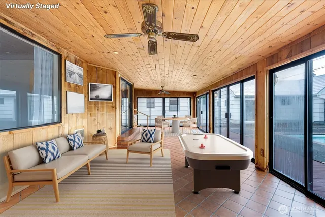 a large room with a large window and furniture